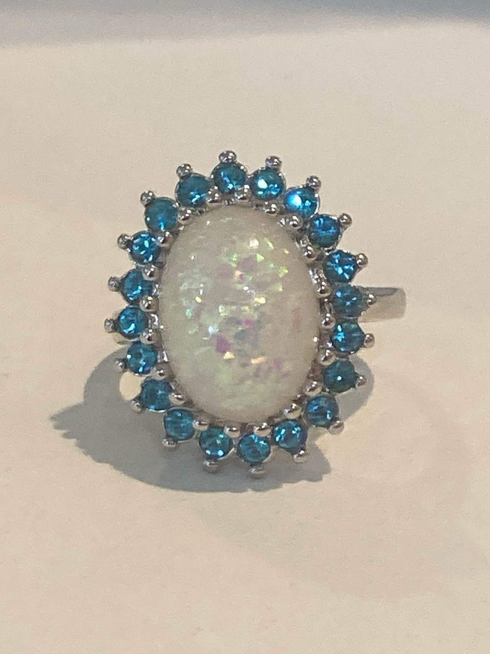 White Opal Oval Halo Ring with Blue Accent Stones